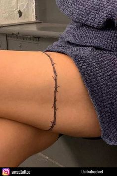 a woman's legs with barbed wire on them and the bottom part of her leg