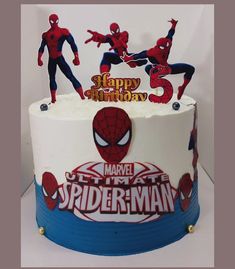 a birthday cake with spiderman decorations on it