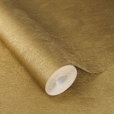 a roll of gold colored fabric with white thread