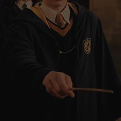 harry potter holding a wand in his right hand