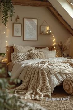 a bed with white blankets and pillows in a room under a slanted skylight