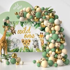 an animal themed birthday backdrop with balloons and jungle animals, including a giraffe