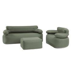 a green couch and ottoman sitting next to each other