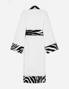 The Zebra pattern on the decorative trimmings of this elegant bathrobe represent a symbolic summary of the dualism at the heart of Dolce&Gabbana’s DNA, which shifts between past and future, artisanship and technology, tradition, and innovation.Soft and comfortable, the bathrobe expresses a strong identity through the sartorial kimono cut. Made of plush cotton terry cloth, the garment is equipped with patch pockets and printed details in linen/cotton along the cuffs, pockets, placket, and bottom Bath Robes For Women, Past And Future, Zebra Pattern, Terry Cloth, Kimono Top, Dolce And Gabbana, Women's Top