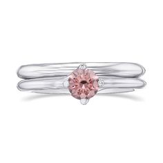 a white gold ring with a pink diamond in the center and two silver bands around it