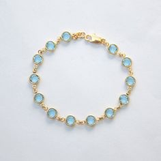 "This March birthstone bracelet features faceted Swarovski crystals in aquamarine, set in gold fill and finished with a lobster clasp. The bracelet measures 7 1/4\" in total length. Please put a note in at checkout if you need a different length. The Swarovski crystals are 6mm across. The last photo shows the Swarovski birthstone colors available in this style, in my shop: https://www.etsy.com/shop/SprigJewelry/search?search_query=birthstone+bracelet Other birthstone jewelry styles are available Elegant Gold Aquamarine Bracelet, Gold Blue Topaz Bracelet, Gold Aquamarine Bracelet Gift, Blue Faceted Crystal Bracelet For Gifts, Blue Faceted Crystal Bracelet Gift, Aquamarine Bracelet, March Birthstone Jewelry, Jewelry Styles, Swarovski Crystal Bracelet