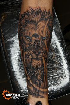 a man's leg with a tattoo on it and a lion in the middle