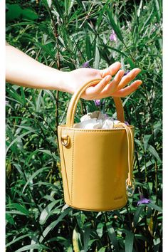 This CAFUNE Mustard Mini Bucket Basket, is probably the most structured bucket bag in the market, its cylindrical shape ensures a roomy interior. Wear it on your shoulder, cross-body, by the top handle or loop it in your arm.COLORMustardCOMPOSITION100% Italian Leather, Lining 100% Canvas DETAILS Drawstring top closure in canvas Cylindrical shapeDetachable adjustable strapBeige cotton lining Gold hardwareDIMENSIONS19 x 14 x 14 cm (H x W x D)0.35 kg (Weight)9.5 cm (Handle Drop)48-54 cm (Shoulder D Gift Bucket Bag With Removable Pouch, Yellow Large Capacity Bucket Bag, Large Capacity Yellow Bucket Bag, Brown Bucket Bag With Adjustable Handle, Shopping Bucket Bag With Adjustable Handle, Bucket Bag With Detachable Strap, Bucket Bag With Adjustable Strap, Bucket Bag With Adjustable Handle For Shopping, Trendy Bucket Bag With Adjustable Strap And Round Handle