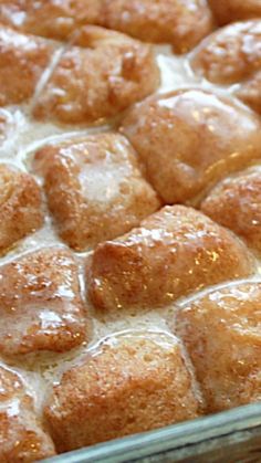 a pan filled with cinnamon rolls covered in icing