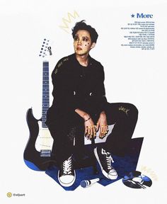 a man sitting on top of a guitar next to a white wall with words written in it