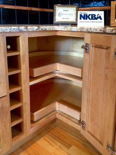 a corner cabinet in the middle of a kitchen