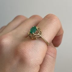 Estate/ vintage 14KT yellow gold oval, genuine emerald band ring. Super unique solitaire ring with an artistic, wavy double gold band setting. Size 9 Can be resized for an additional fee .75 carat medium green color oval emerald 7 mm x 6.75 mm Inclusions which is typical of a natural emerald Weight: 2.5 grams Mid century design Excellent Estate Condition Clearly Antique Style Heirloom Oval Emerald Ring, Oval Emerald Ring In Gold, Heirloom Oval Emerald Ring With Ethical Gemstones, Fine Jewelry Hallmarked Oval Emerald Ring, Oval Hallmarked Emerald Ring Fine Jewelry, Oval Hallmarked Emerald Ring In Fine Jewelry Style, Classic Emerald Ring Oval Cabochon Stamped 14k, Hallmarked Oval Emerald Ring In Fine Jewelry Style, Classic 14k Stamped Oval Cabochon Emerald Ring