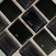 eight black leather business cards laid out in rows