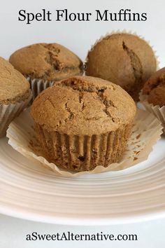 several muffins on a white plate with the words spell flour muffins