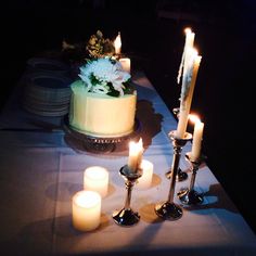 a table with candles and a cake on it