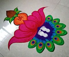 a colorful design on the floor with peacock feathers