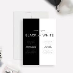 the black and white wedding card is next to some confetti on a table