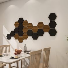 a dining room table and chairs in front of a wall with hexagonal pieces on it