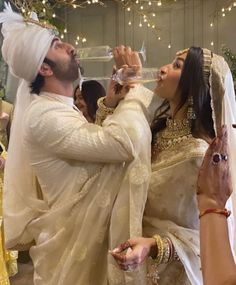 the bride and groom are drinking wine together