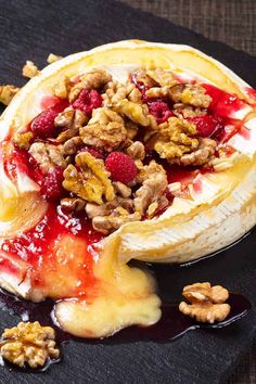 raspberry walnut baked brie with pecans on the side and drizzled in syrup