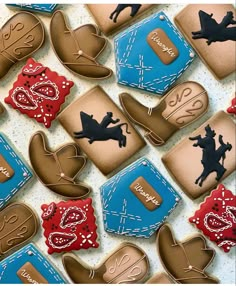 decorated cookies in the shape of cowboy boots and horses