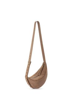 the sling bag in tan suede is shown with an adjustable strap and zipper closure