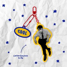 an image of a man wearing a tie and holding a keychain with the word cool on it