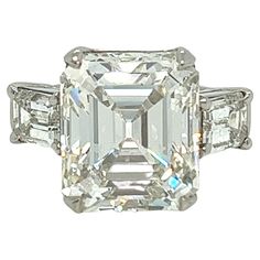 an emerald cut diamond ring with three baguets