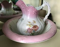 a pink and white vase sitting on top of a table