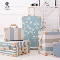 four pieces of luggage sitting on the floor in front of a white cabinet and door