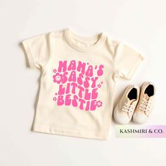 "Your toddler will look adorable in this \"MAMA'S SASSY LITTLE BESTIE\" Toddler short sleeve tee. This lightweight side-seamed shirt maximizes comfort all day long.  Mamas Sassy Little Bestie Toddler Shirt, Funny Retro Sassy Soul Toddler Shirt, Baby Girl Tee, Funny Mommas Bestie Tee, Cute Mini Me TShirt 🌟100% Airlume combed and ringspun cotton (fiber content may vary for different colors) 🌟Light fabric (3.9 oz/yd² (132 g/m 🌟Retail fit RETURNS: All products are made-to-order and because of the nature of these items, all sales are final unless they arrive damaged or defective. CARE INSTRUCTIONS Turn Inside Out. Machine wash: cold (max 30C or 90F); Non-chlorine: bleach as needed; Tumble dry: low heat; Iron, steam or dry: medium heat; Do not dryclean. PLEASE SEE THE SIZING CHARTS for the me Toddler Girl Shirt Ideas, Pink Playful Tops With Funny Text, Playful Pink Tops With Funny Text, Unisex Pink Playful T-shirt, Unisex Cute Tops With Funny Text, Cute Unisex Tops With Funny Text, Cute Unisex Slogan Tops, Cute Tops With Name Print For Playtime, Cute Letter Print Shirt