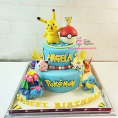 a pokemon themed birthday cake with pikachu and other characters on the top tier