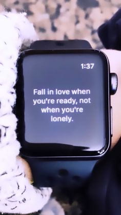 someone holding a smart watch with a quote on it