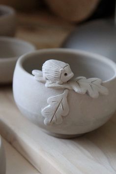 a white bowl sitting on top of a wooden table