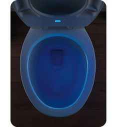 an illuminated toilet bowl with the lid up