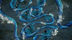 an aerial view of several people in blue dresses floating on the water with their backs to each other