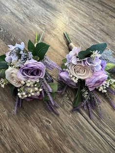 two bridal bouquets with purple flowers and greenery on a wooden table top