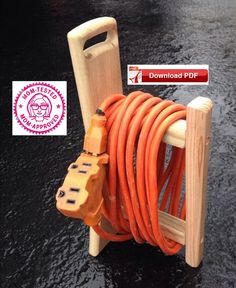 an orange hose is attached to a wooden stand