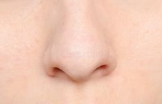 the nose of a woman with freckles on it