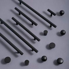 black handles and knobs are arranged on a gray surface