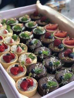 a box filled with lots of different types of desserts on top of each other