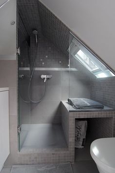 a bathroom with a sink, toilet and shower in it's corner stall next to the bathtub