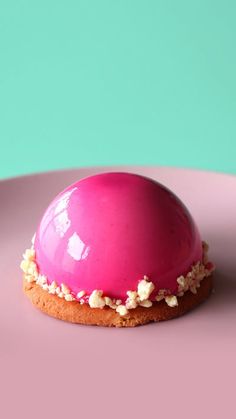 a pink dessert sitting on top of a pink plate