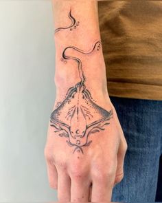 a person with a tattoo on their hand