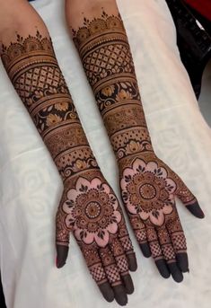 two hands with henna tattoos on them