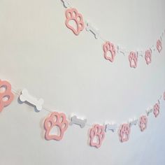 pink and white dog paw print bunting decorations on a string with bone shaped cut outs