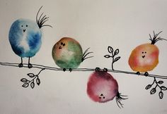 three colorful birds sitting on a wire with leaves