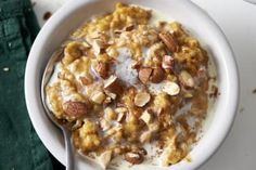 a white bowl filled with oatmeal and nuts