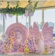 there is a display with flowers and fairy wings