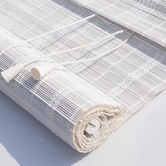 a roll of white wicker sitting on top of a table